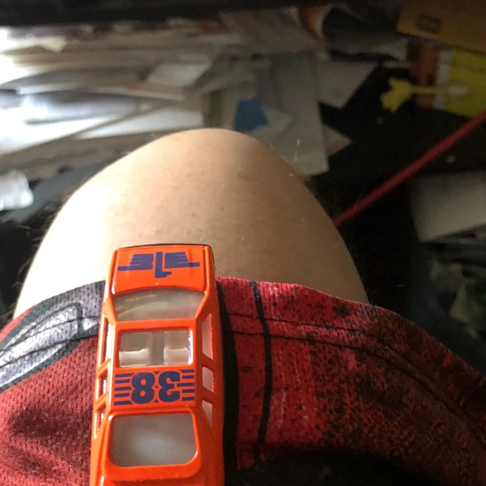 Orange Diecast Toy Race Car with Blue Number Graphics